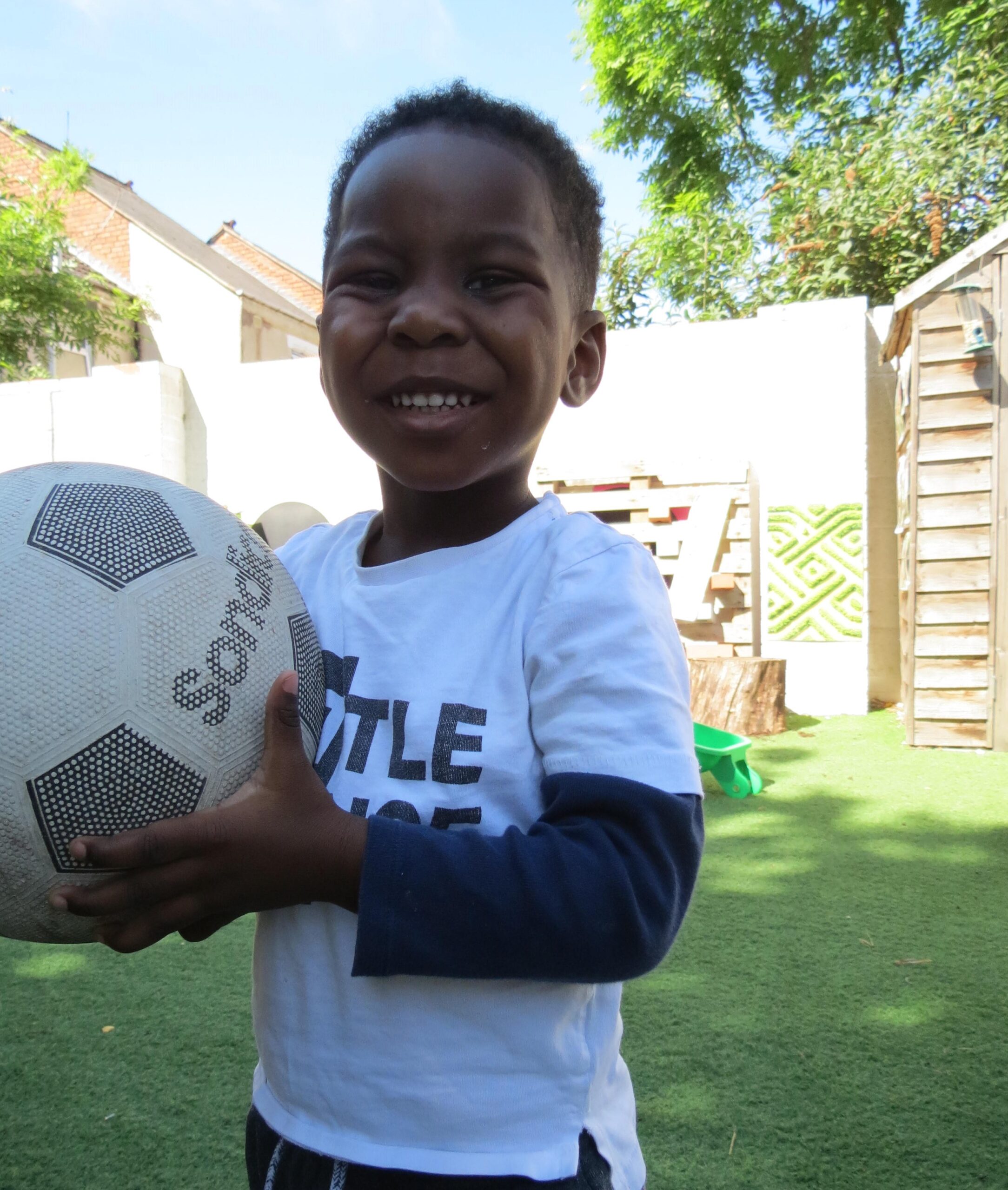 Boy playing football at George Eliot Kindergarten